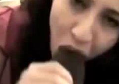 Skanky girl sucking big black dick while talking to her BF on a phone
